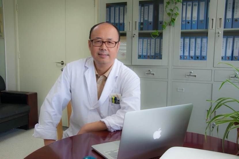 人拿着笔记本电脑的桌子前 描述已自动生成